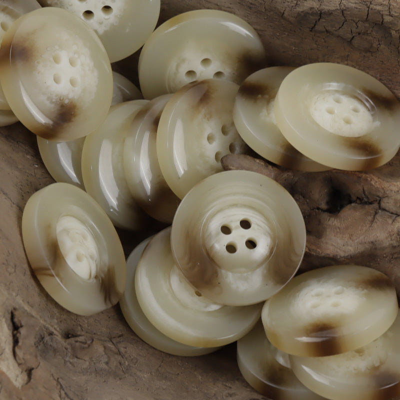 Cream resin buttons with horn pattern and wide edge, round with 4 holes