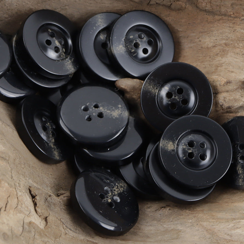 Black resin buttons with horn-like swirls, round wide edge, 4 holes set
