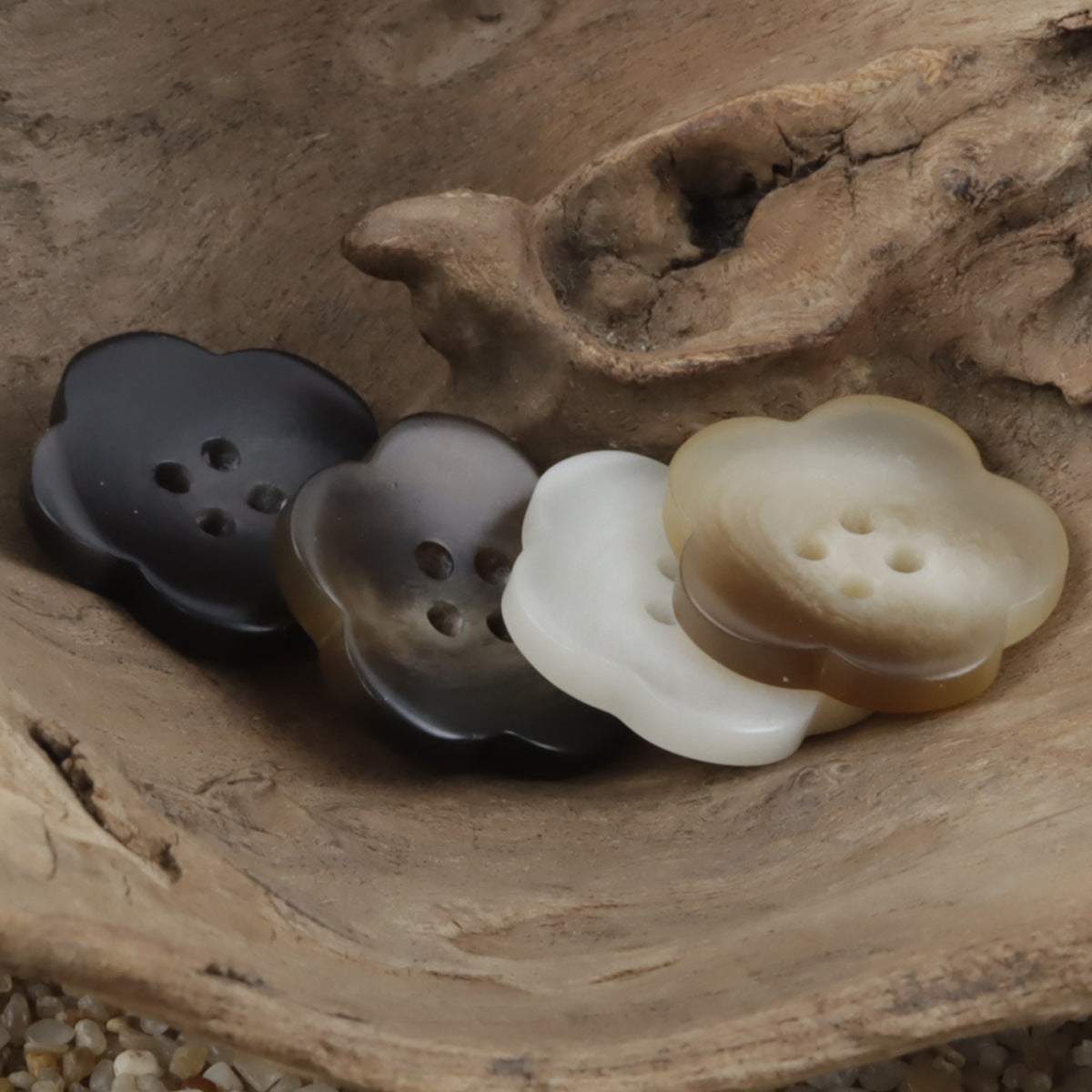 Flower-shaped amber resin buttons in dark, gray and white tones, each with 4 holes