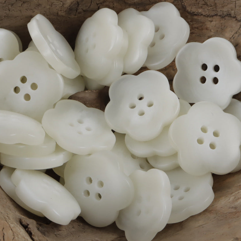 White flower-shaped amber resin buttons, each with 4 holes, glossy front
