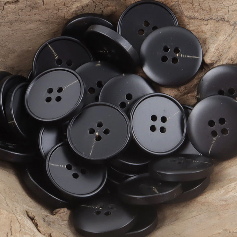 Matte black round resin buttons, four holes, mixed-button close-up