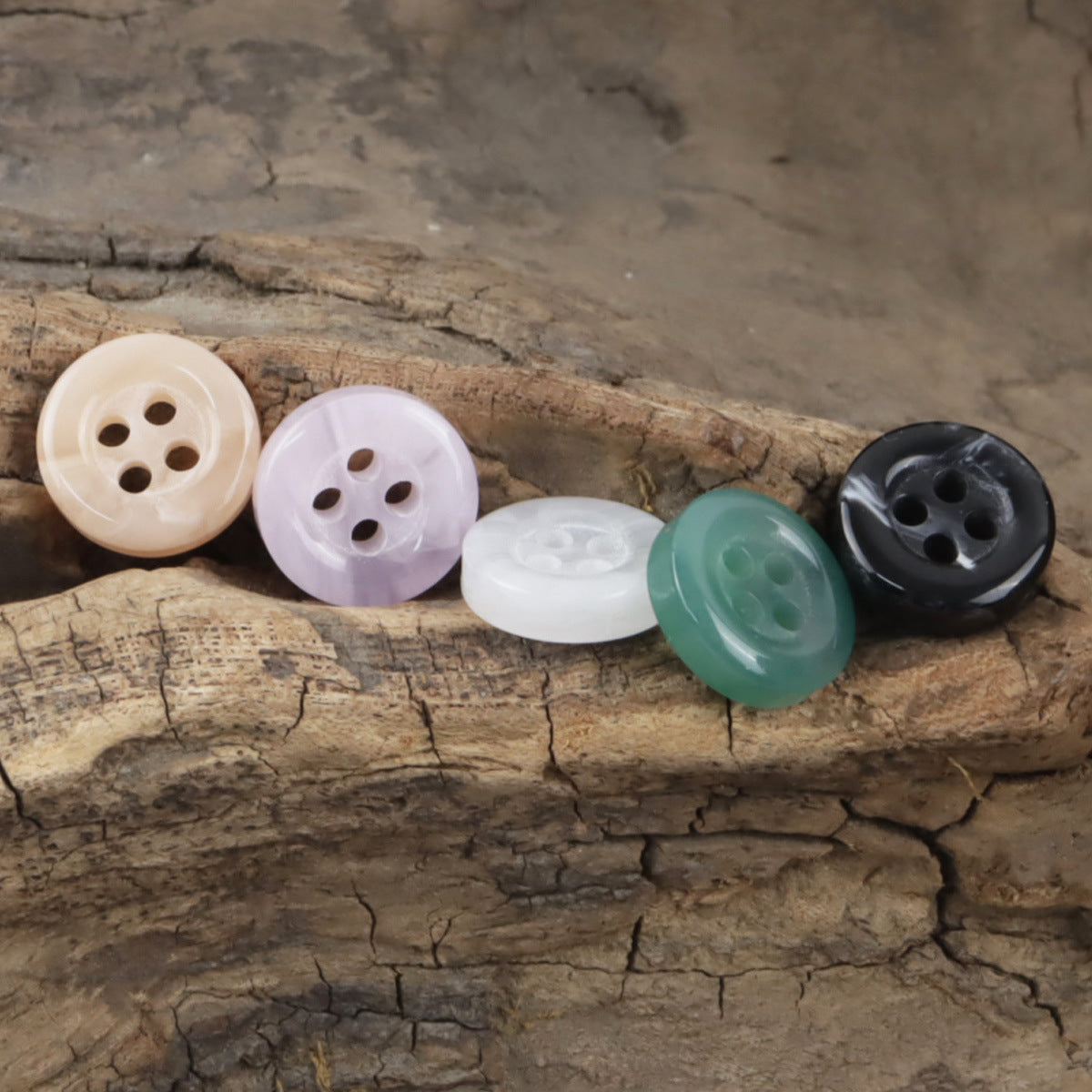 Assorted 11.5mm resin buttons, 4-hole: white, lilac, green, black on wood log