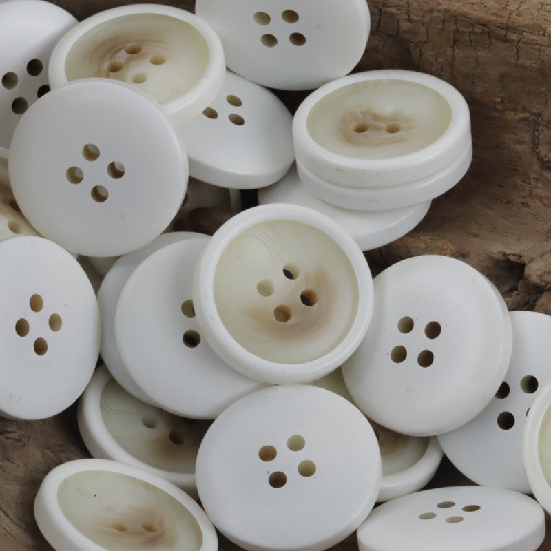 Set of round white resin buttons with 4 holes, children’s shirt style