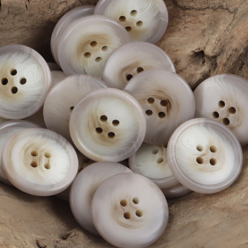 Round pale cream resin buttons with 4 holes, smooth striped resin texture
