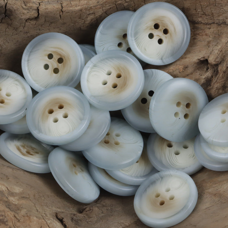 Round light blue resin buttons with 4 holes, smooth semi-matte surface