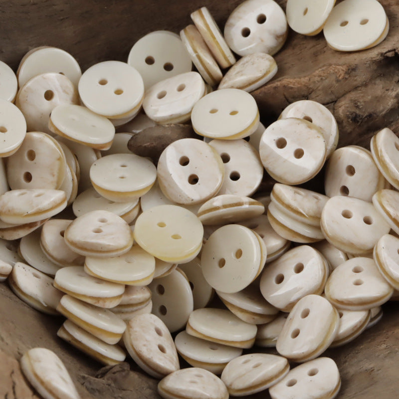 Mixed 2-hole resin shirt buttons in cream and pale beige tones, round fronts
