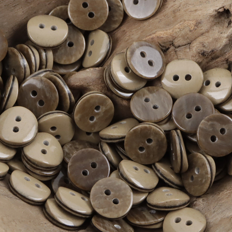 Assorted 2-hole resin shirt buttons in tan and light brown tones, round style