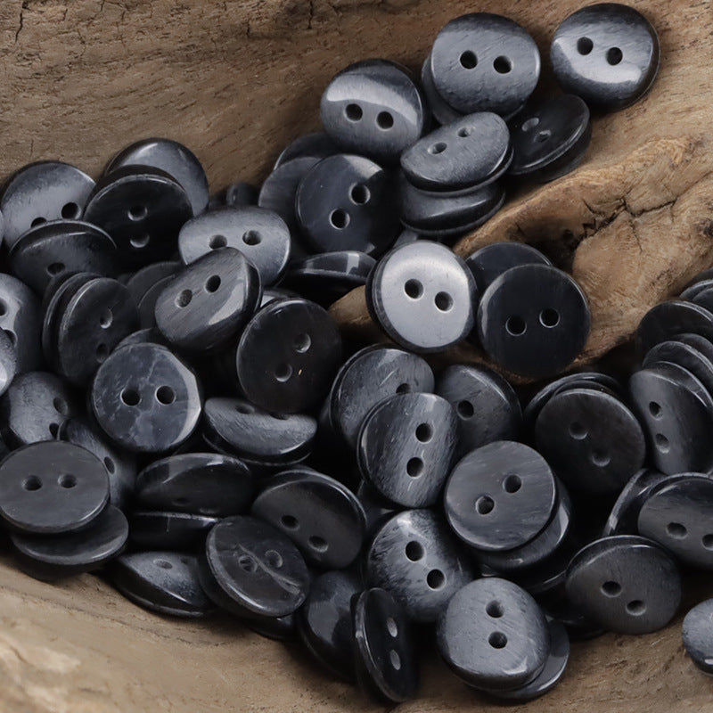 Round 2-hole resin shirt buttons in dark blue-gray tones, visible front faces