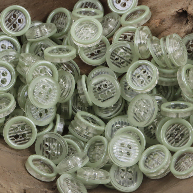 11.5mm transparent resin 4-hole buttons, many in light green translucent tones