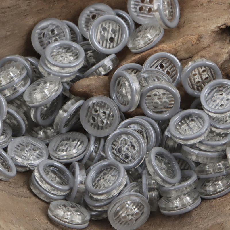 11.5mm transparent resin 4-hole buttons, many in light gray with clear inner shanks