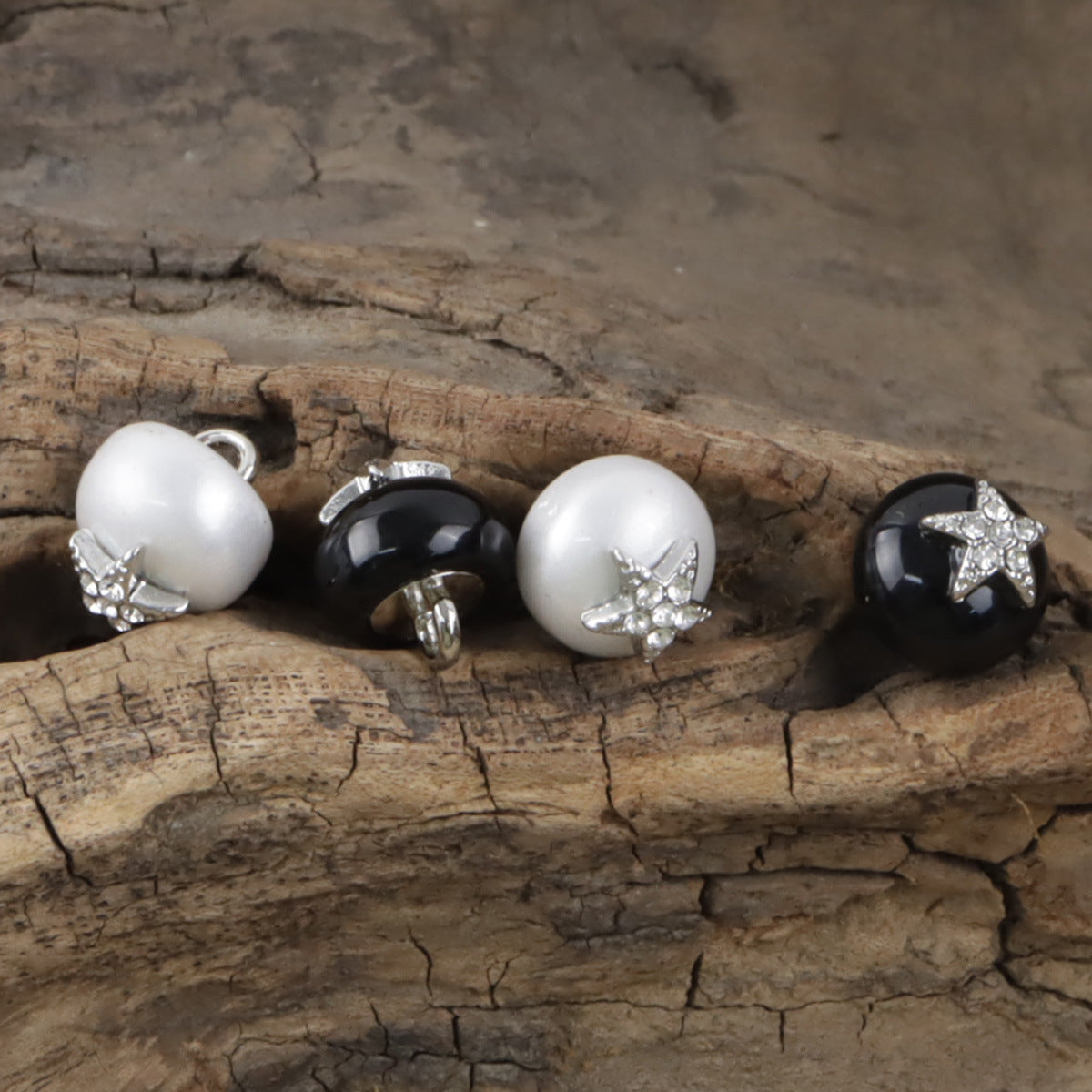 Back view of 11.5mm starfish rhinestone buttons: white and black resin, metal loops