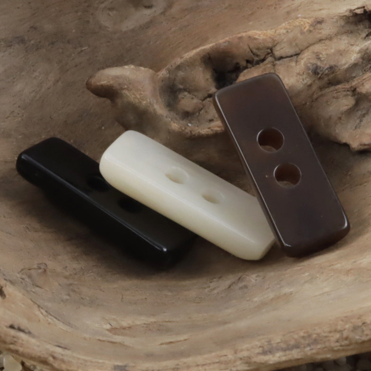 Two-hole toggle resin buttons in black, beige, and coffee shades