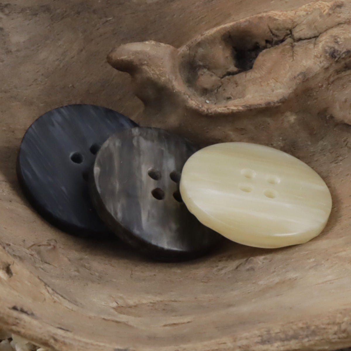 Beige and dark gray/black flat resin buttons with woodgrain stripes, 4-hole design
