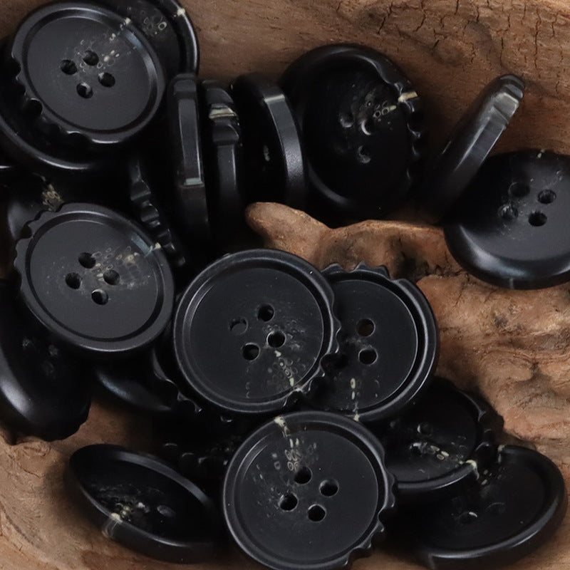 Black chipped resin buttons, round with ridged edges and 4 holes, mixed pieces