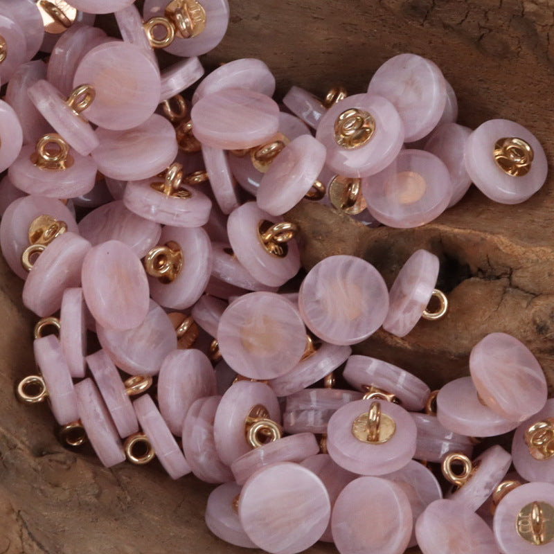 Round resin shank buttons pile in light pink/pastel with gold-tone shanks