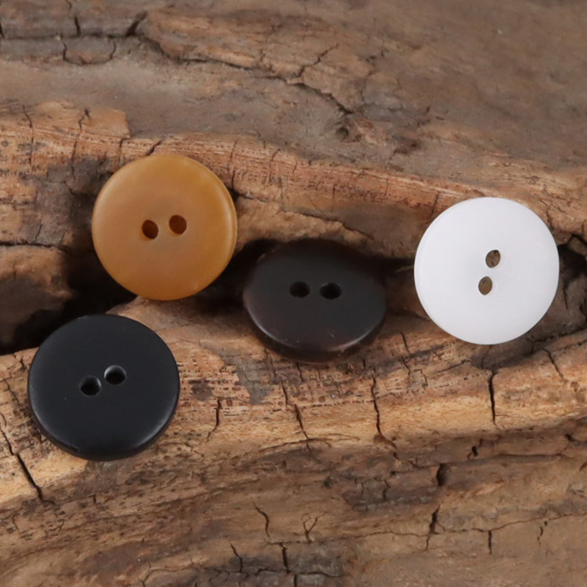 2-hole resin buttons assortment: white, dark, and tan/brown gradient crescent styles