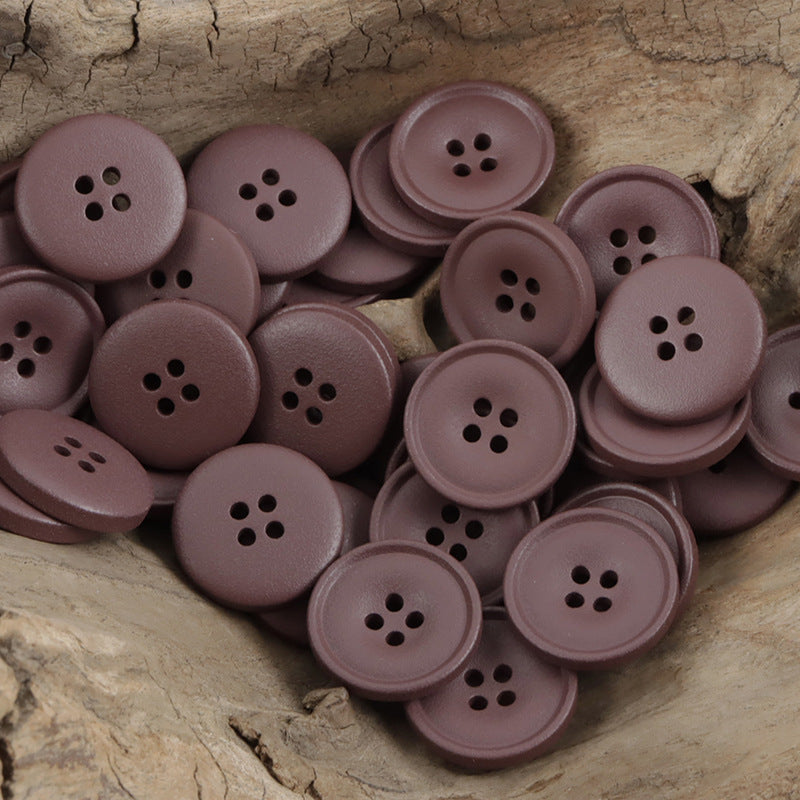 Matte resin coat buttons in wine/mauve purple with round 4-hole fronts