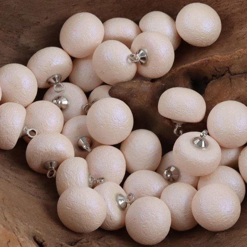 Milk white round resin buttons with metal loop backs, close-up group