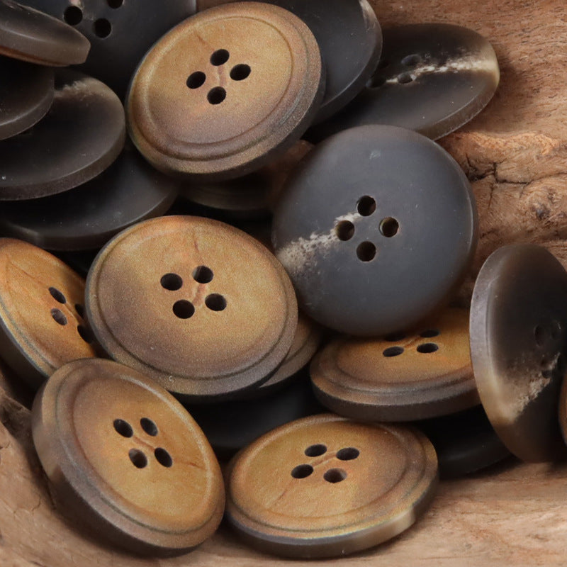 Assorted round 4-hole vintage resin buttons in burnt yellow and dark charcoal/black