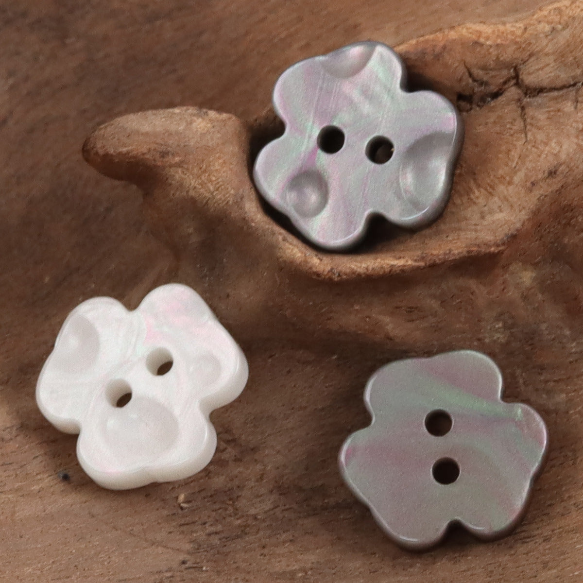 Assorted two-hole flower resin buttons: light, iridescent light pink, and dark gray