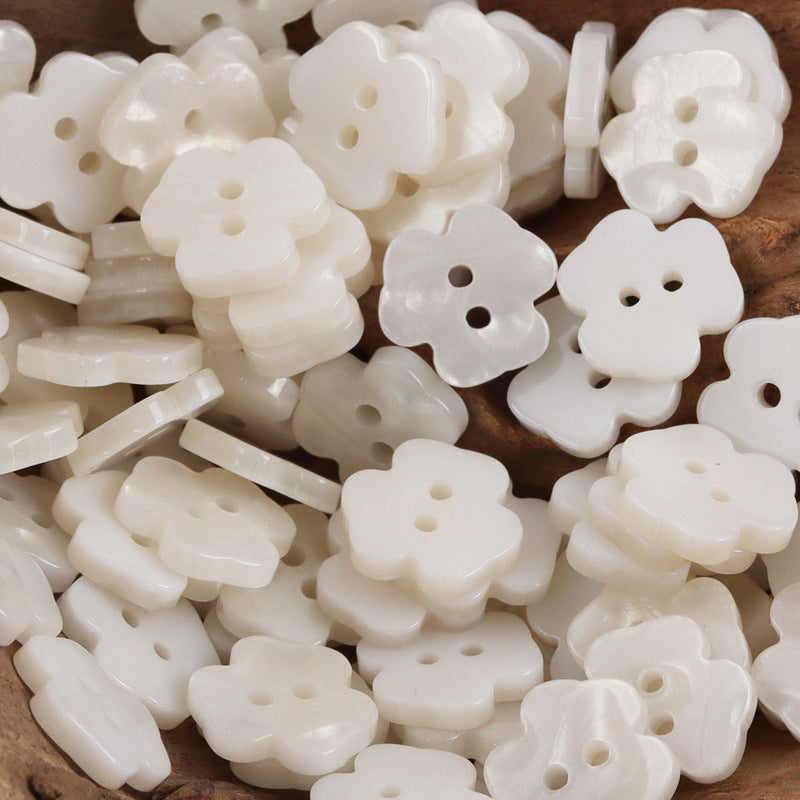 White flower resin buttons (2 holes), stacked close-up showing flower cutouts