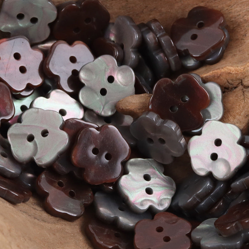 Assorted two-hole flower resin buttons in dark gray, black, and brown tones