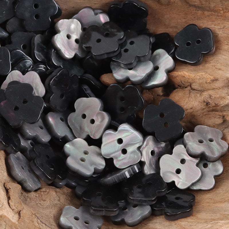 Black and silvery two-hole flower resin buttons, many pieces shown together