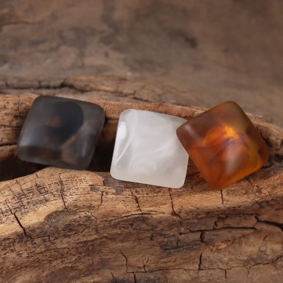 Square resin buttons with metal shanks: black, white, and amber squares