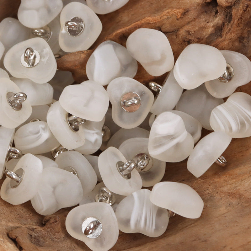 White heart-shaped resin lingerie buttons, many pieces with metal shanks.