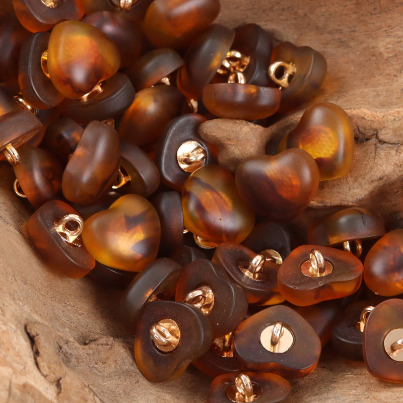 Amber and dark heart-shaped resin lingerie buttons, mixed set with metal shanks.