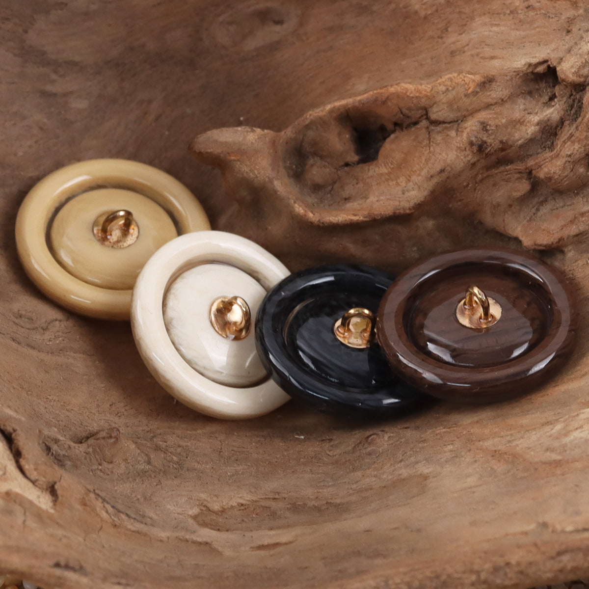 Round resin buttons with metal shanks in cream, white, dark brown, and black