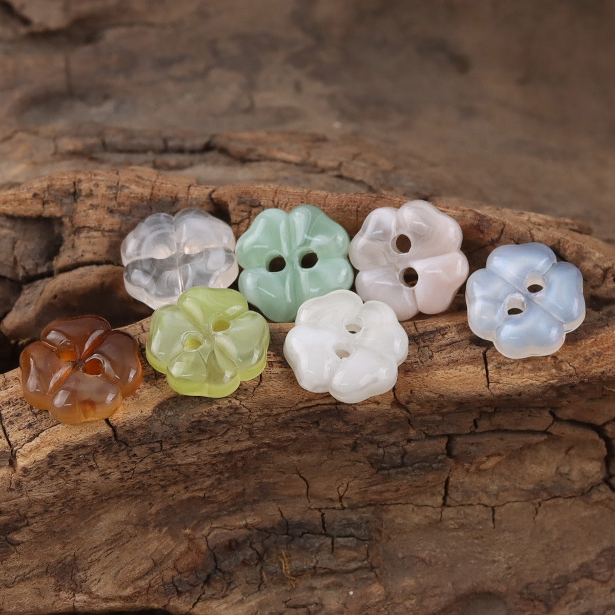 Assorted cherry blossom resin buttons in clear white, green, light blue, and coffee