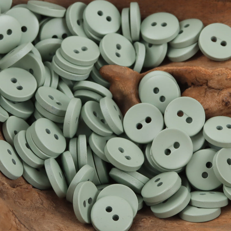 Light mint and white 2-hole resin buttons, round 11.5mm.