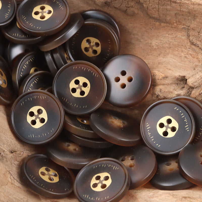 Round 4-hole resin buttons in dark gray with gold-tone shank, multiple buttons