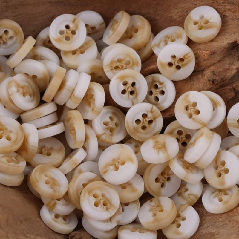 Mixed round 4-hole resin buttons, cream/ivory with warm tan swirls