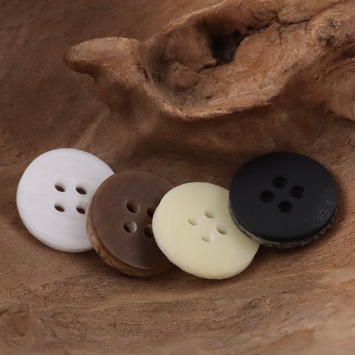 Round 4-hole resin buttons: white, light beige, brown/tan, and dark gray with wood-grain