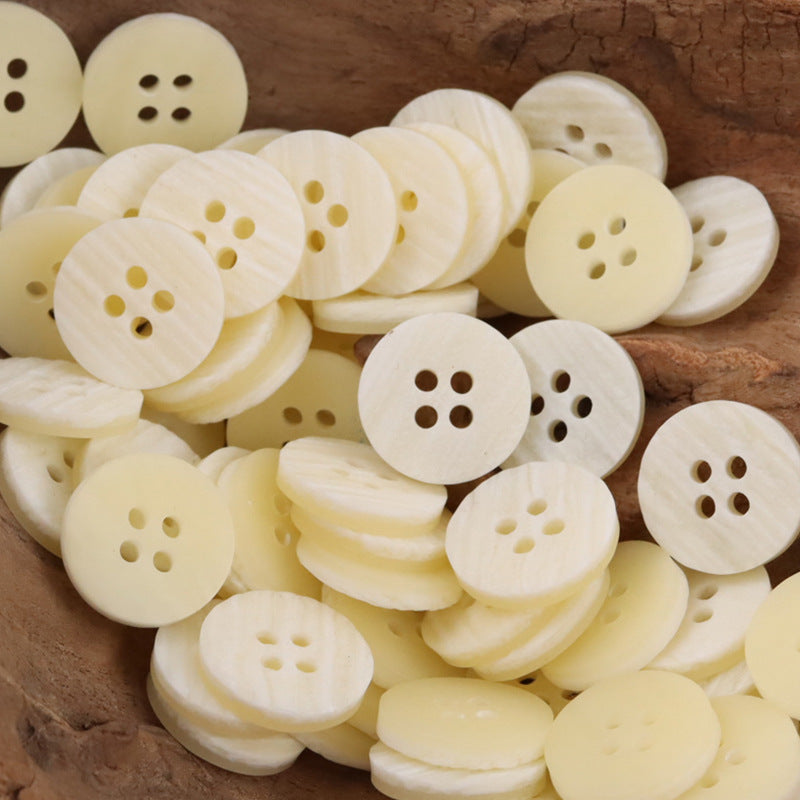 Light beige/cream round resin buttons with wood-grain look, 4-hole design