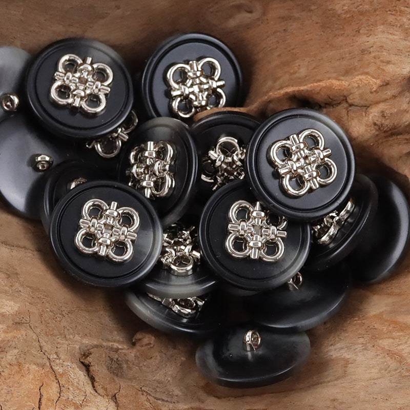 Black resin coat buttons with silver-tone Chinese knot metal fronts and metal shanks, group view