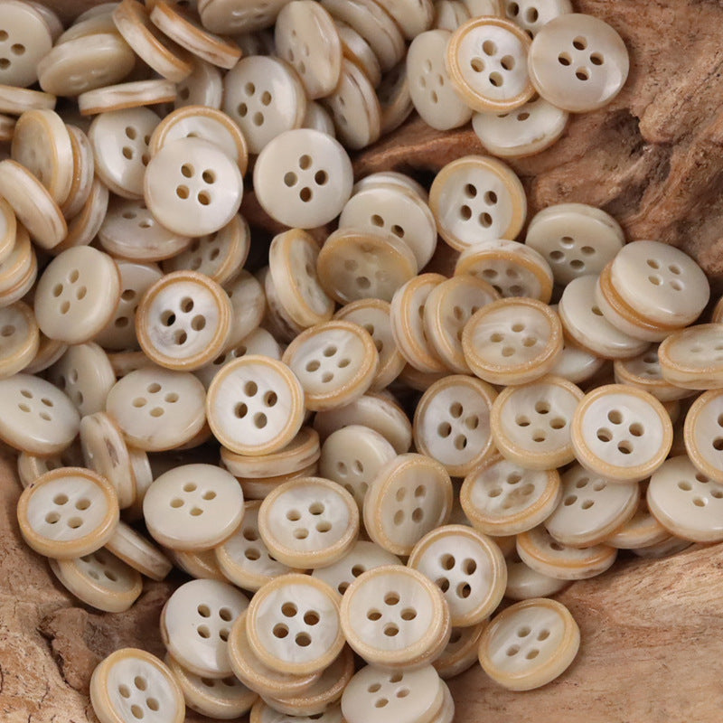 11.5mm khaki resin buttons, round four-hole style, bulk pack on wood