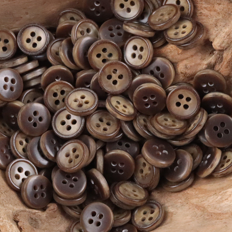11.5mm coffee-brown resin buttons, round four-hole style, bulk pack on wood