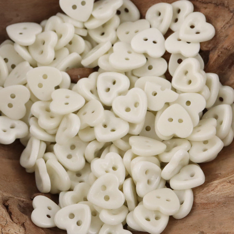Ceramic heart buttons—white style with two holes, mixed pile.