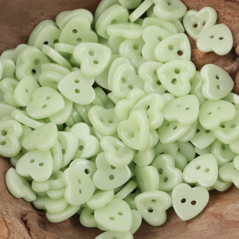 Ceramic heart buttons—light green style with two holes, mixed pile.