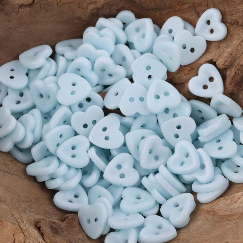 Ceramic heart buttons—light blue style with two holes, mixed pile.