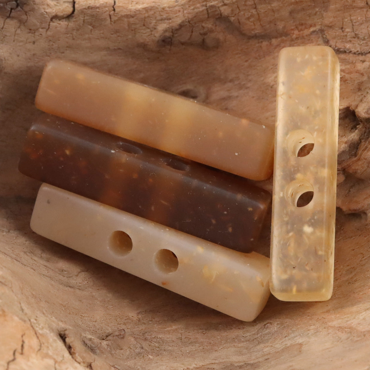 Two-hole long resin buttons, wood chip pattern, caramel and lighter beige mix
