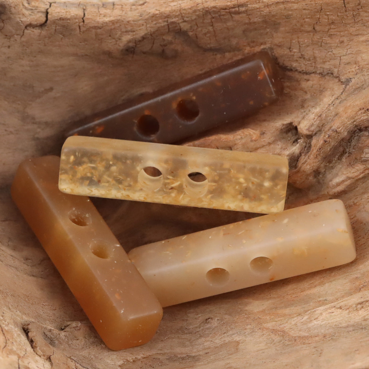 Two-hole long resin buttons with wood chip pattern, translucent beige and dark brown