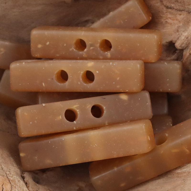 Two-hole long resin buttons, wood chip pattern, light tan translucent (multiple pcs)