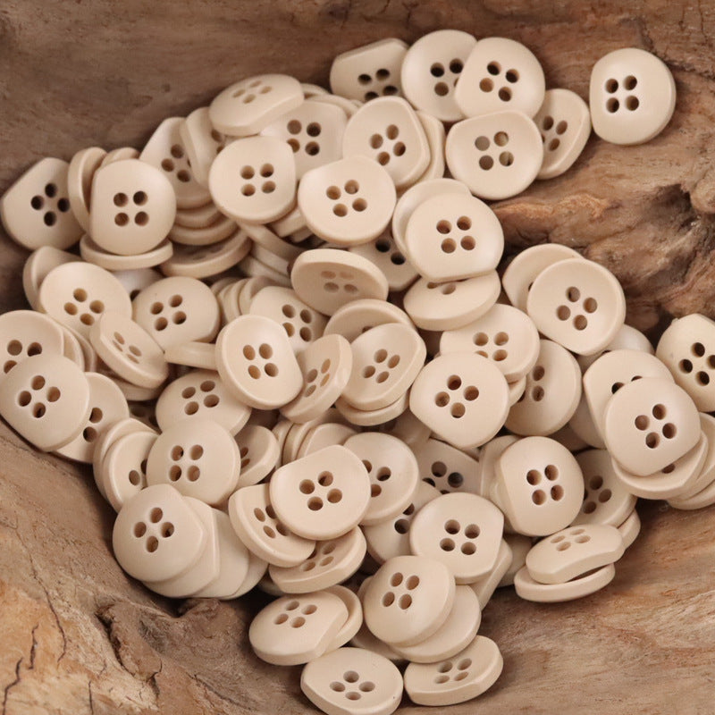 Bulk cream/beige semi-circular resin buttons with four-hole centers