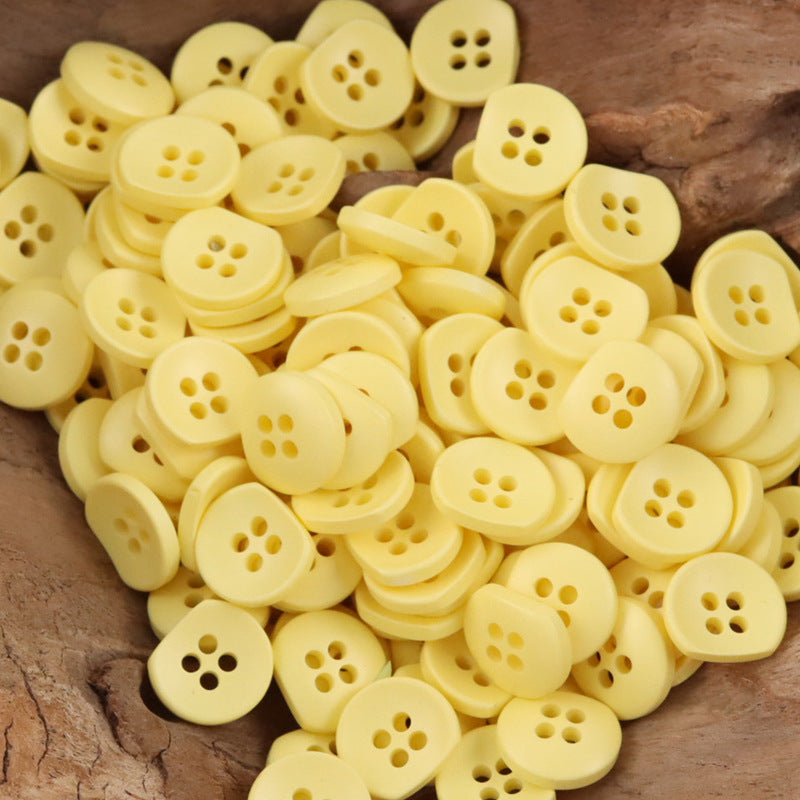 Bulk pale yellow semi-circular resin buttons with four holes