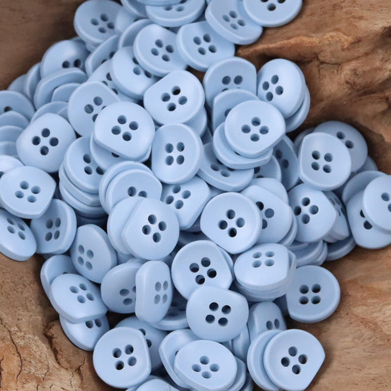 Bulk light blue semi-circular resin buttons with four holes