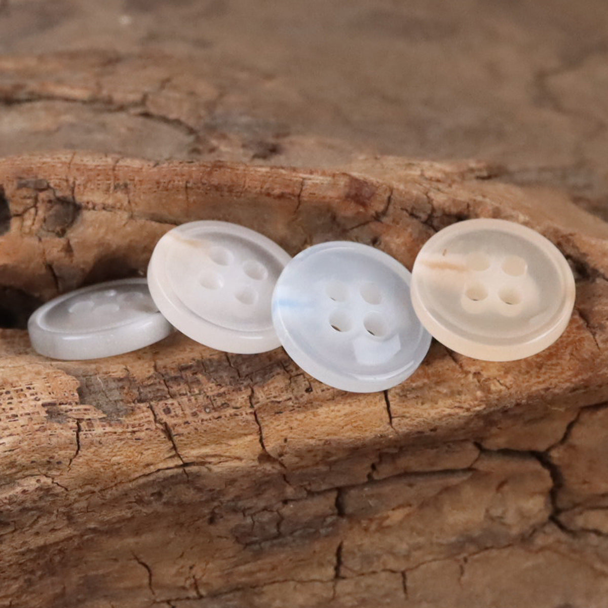 Semi-transparent 11.5mm resin shirt buttons, white/light gray, four-hole view
